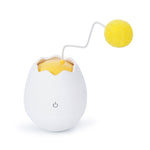 Cat playing with interactive cotton ball toy